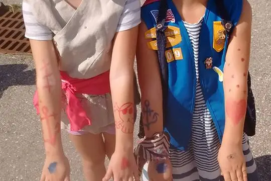 Kids smile with their pirate face paint